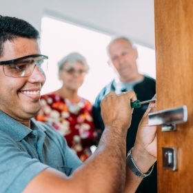 Close-up,Of,Male,Hands,Repair,Or,Installing,A,Metal,Door